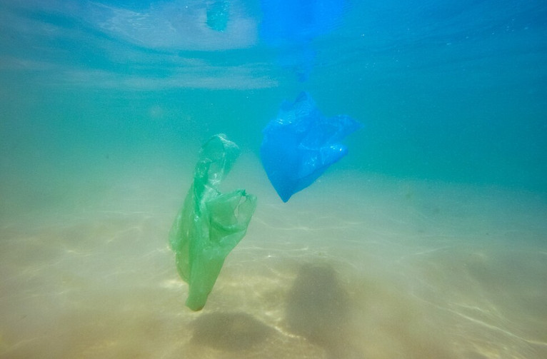Plastic waste drifting down to the ocean floor.